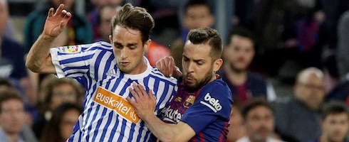 Barcelona's Jordi Alba vies with Adnan Januzaj of Real Sociedad