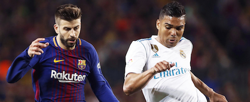 Barcelona's Gerard Pique with Casemiro of Real Madrid