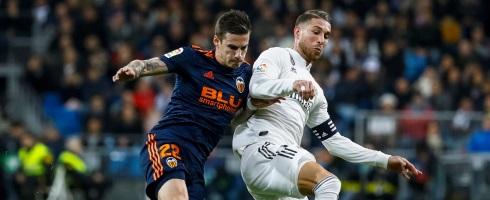 Valencia's Santi Mina and Sergio Ramos of Real Madrid