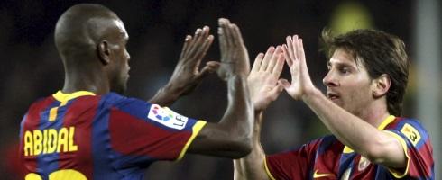 Eric Abidal and Lionel Messi at Barcelona