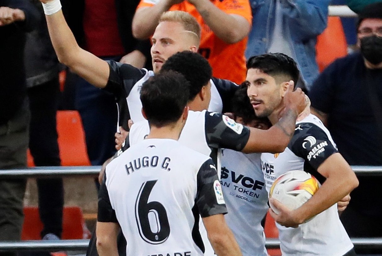 Valencia score two injury-time goals to secure dramatic point against Atletico Madrid