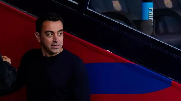 Xavi Hernandez looks on from down the tunnel.