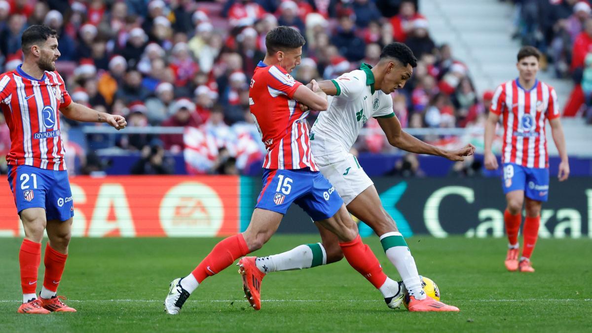 Lenglet puts in a tackle.