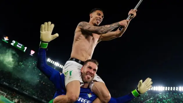 Antony celebrates the derby on Adrian's shoulders.