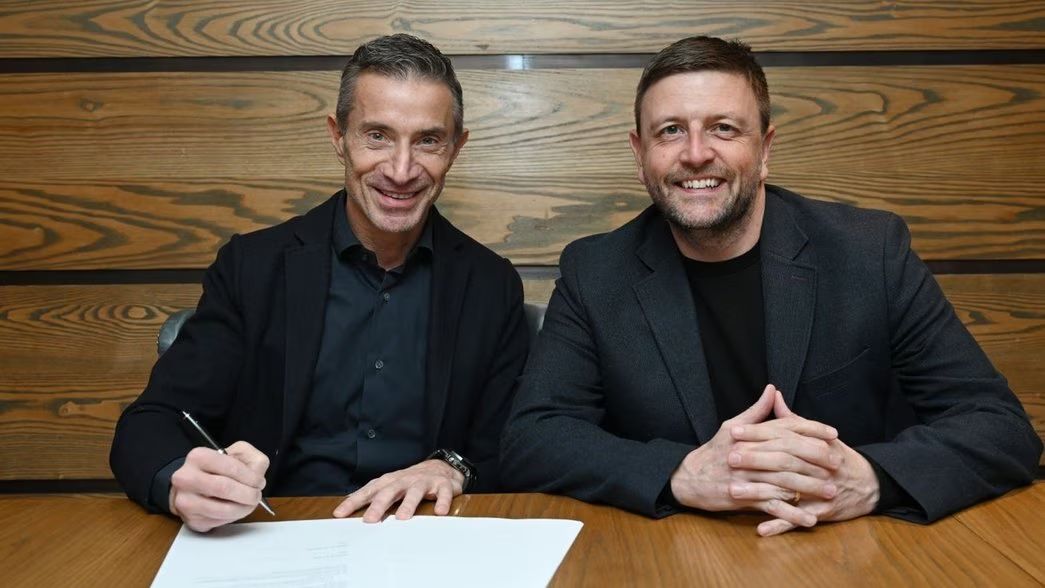 Berta signs his contract at Arsenal.