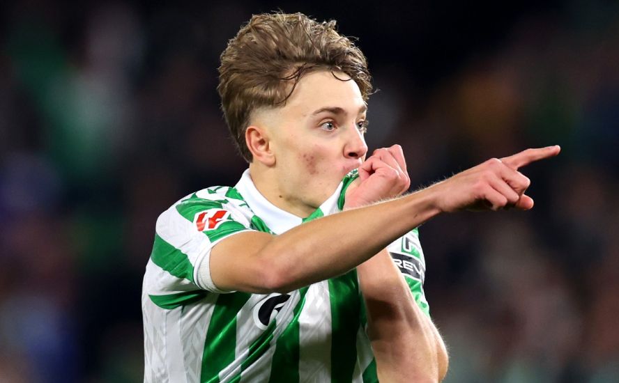Jesus Rodriguez kisses the Betis badge.