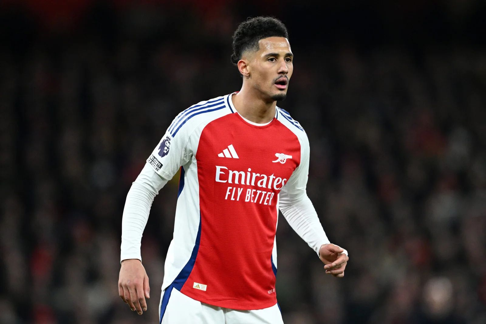 William Saliba looks on as he defends for Arsenal.