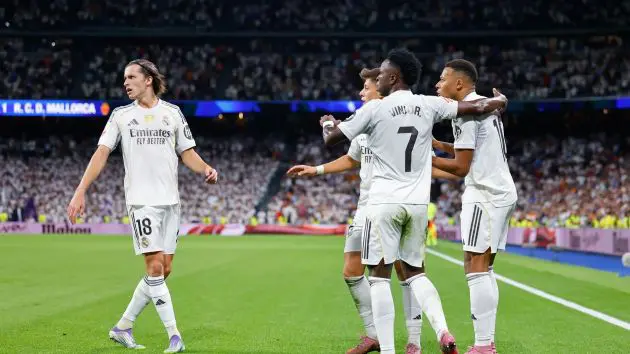 Vinicius Junior celebrates with Kylian Mbappe.
