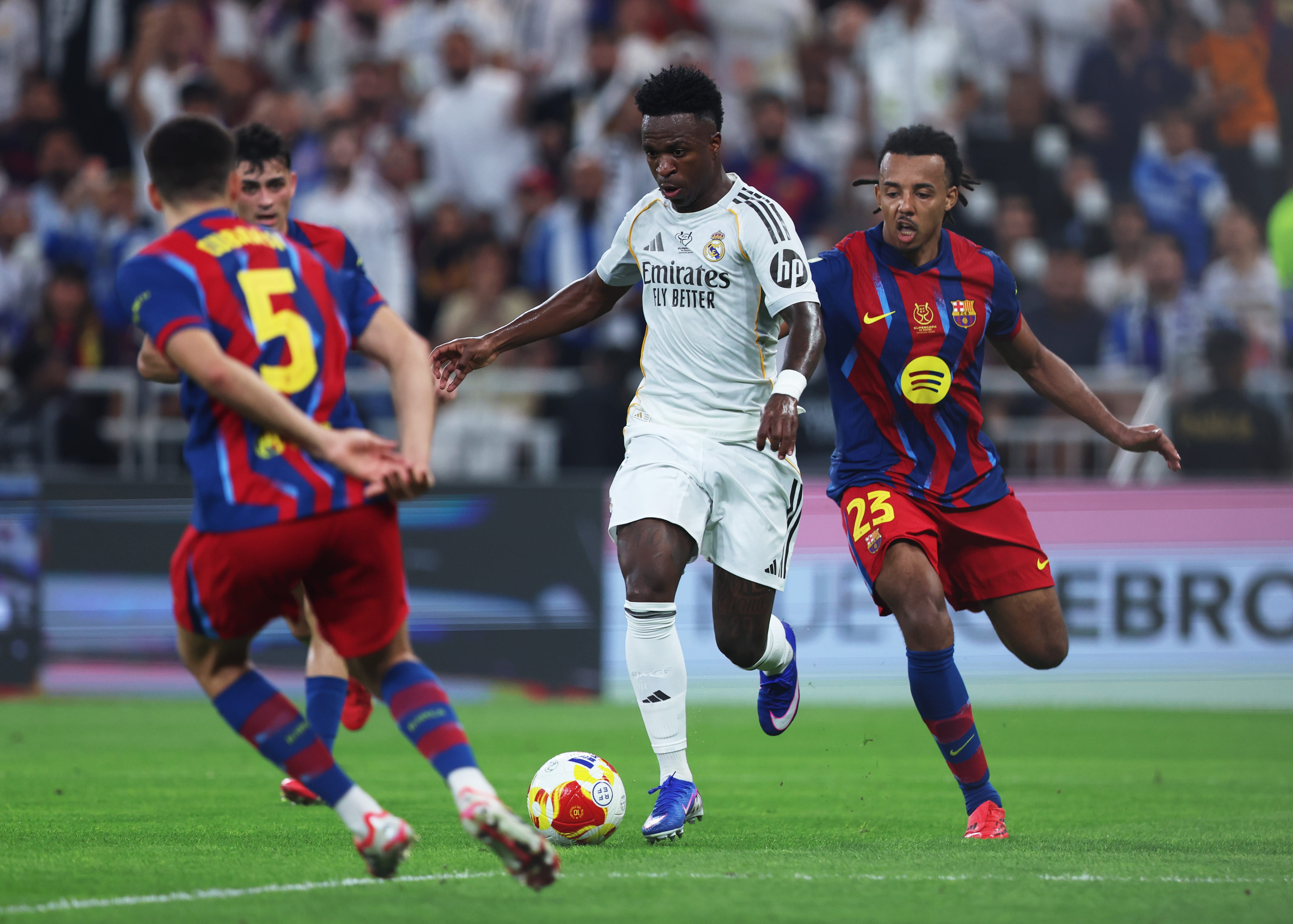 Vinicius blazes past Kounde.