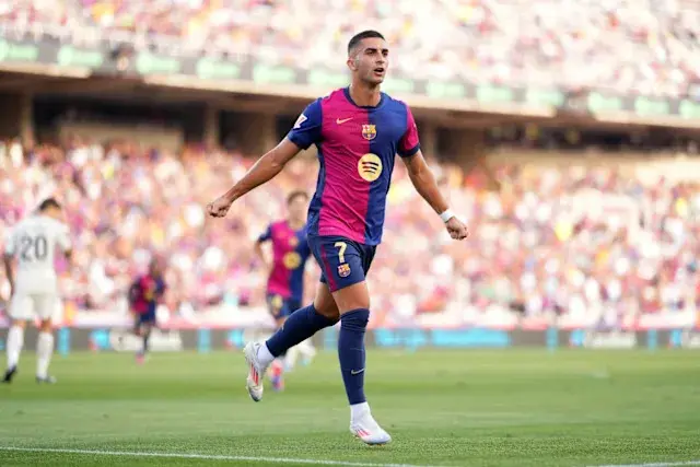 Ferran Torres celebrating a goal in FC Barcelona's jersey during a match.