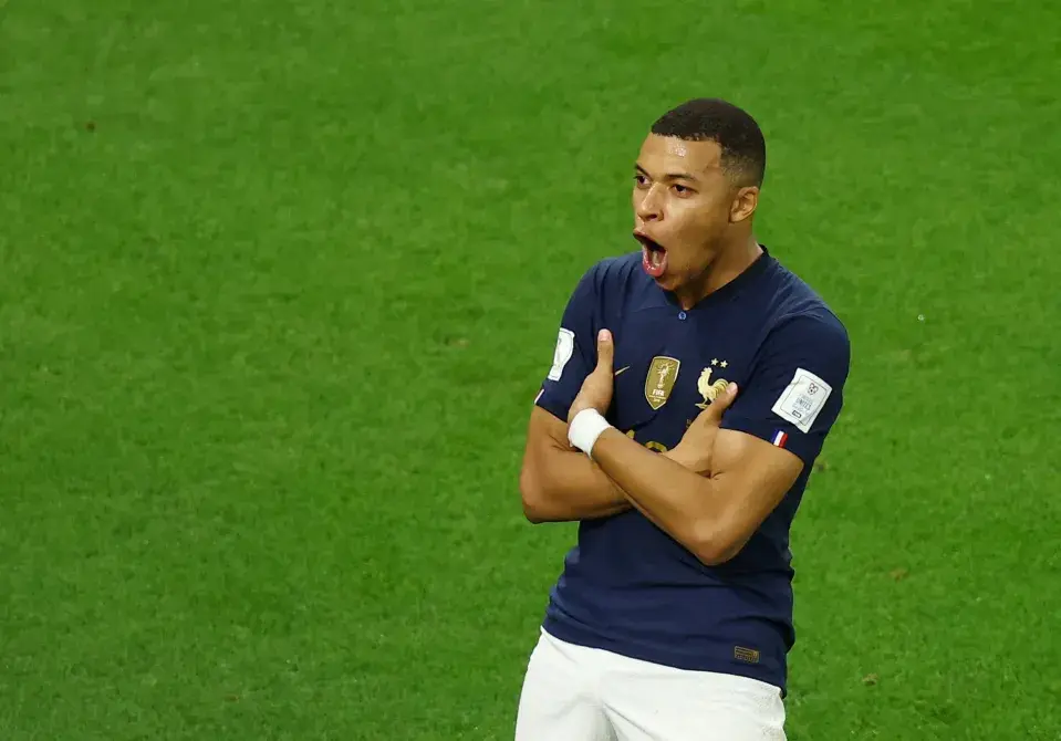Kylian Mbappe celebrating on the field during a match for France.