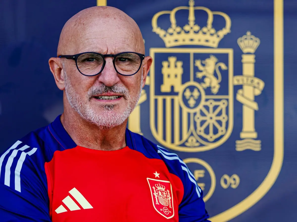 Portrait of Luis de la Fuente wearing a red and blue Spain national team training shirt