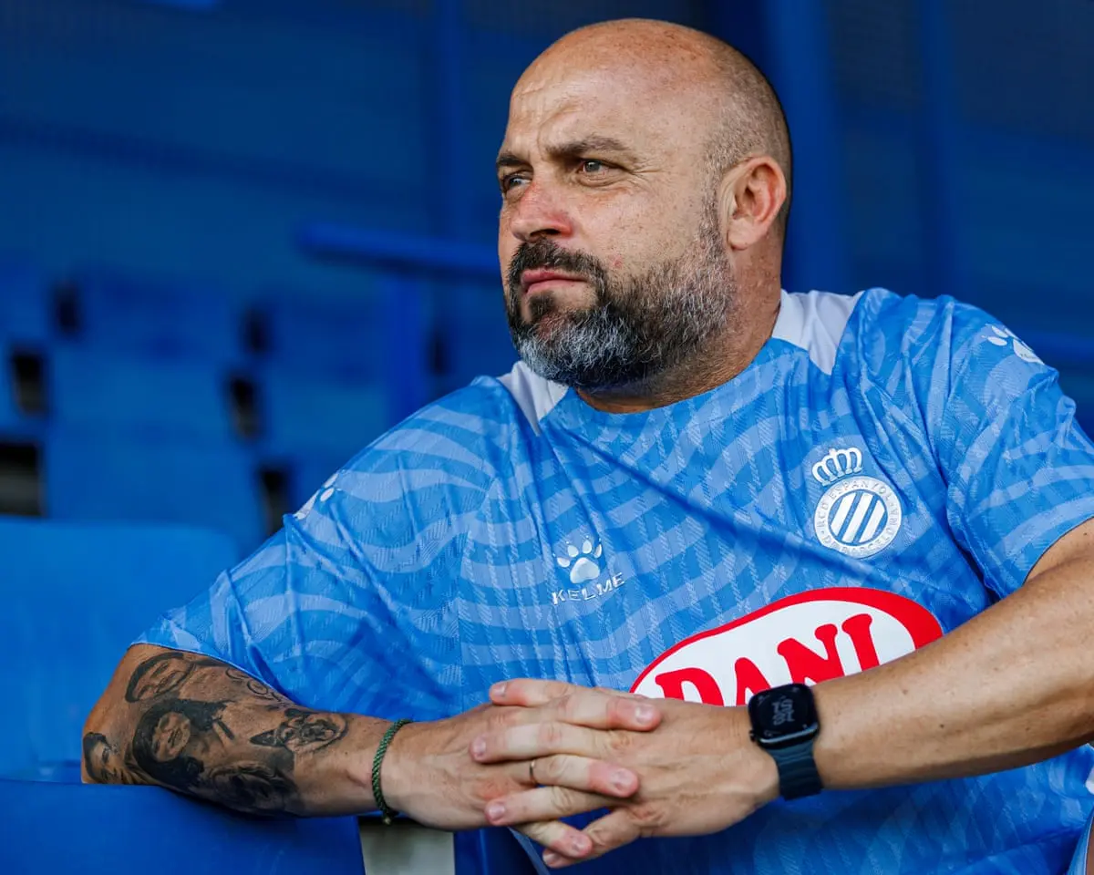Manolo Gonzalez Espanyol wearing a blue sports jersey, seated in a stadium.