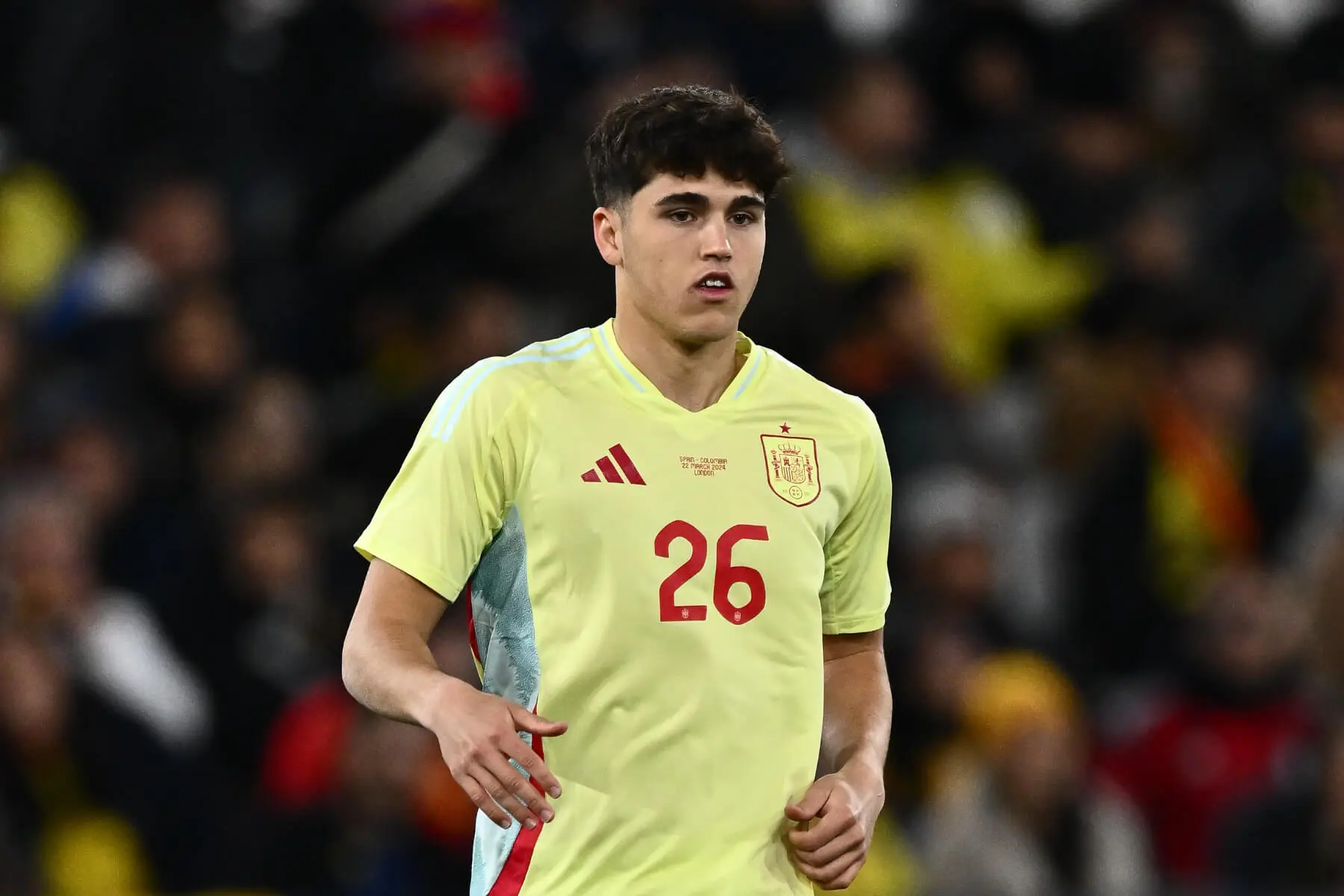 Young soccer player wearing Spain national team jersey during a match.