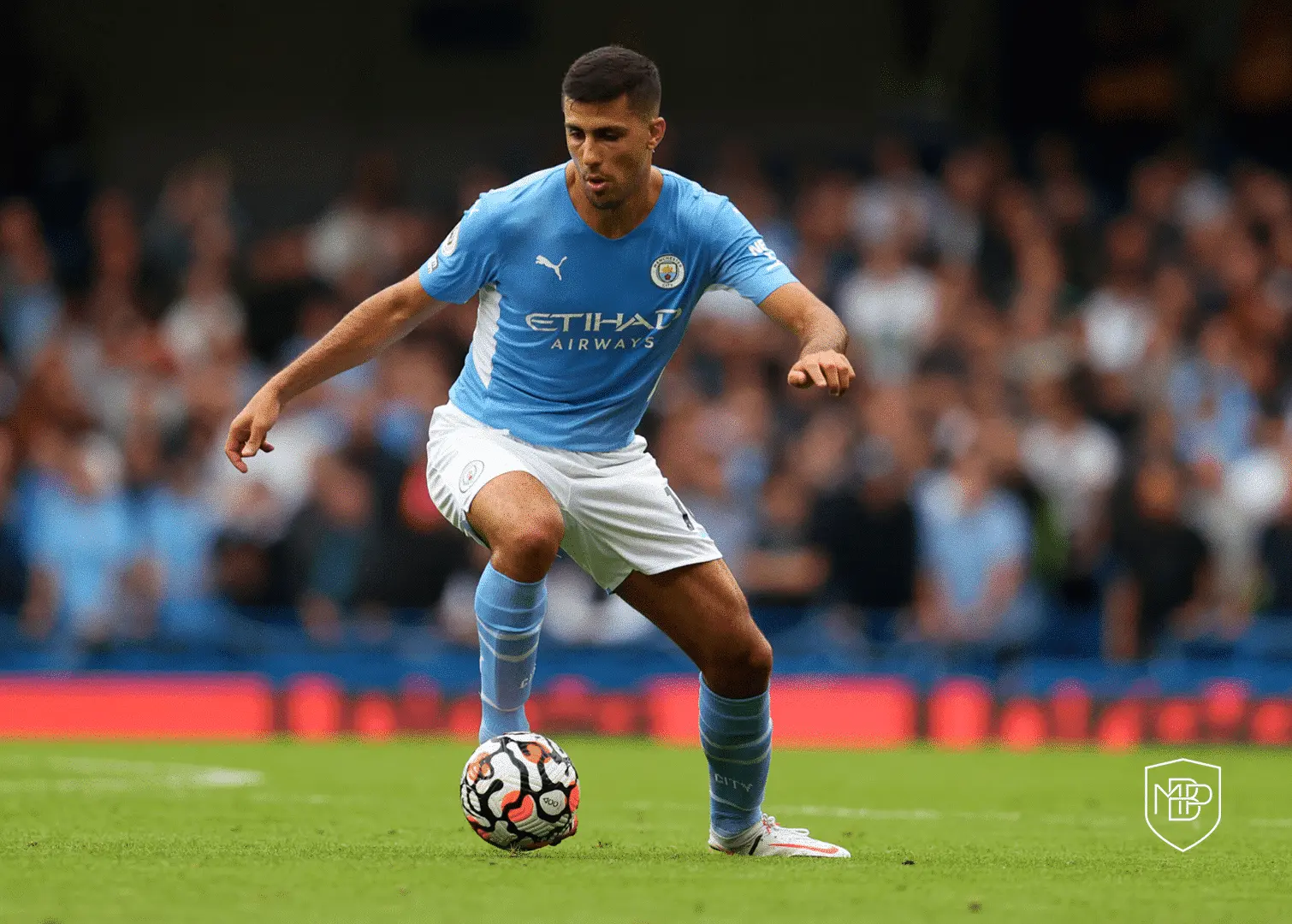 Manchester City midfielder Rodri controlling a soccer ball on the pitch during a match