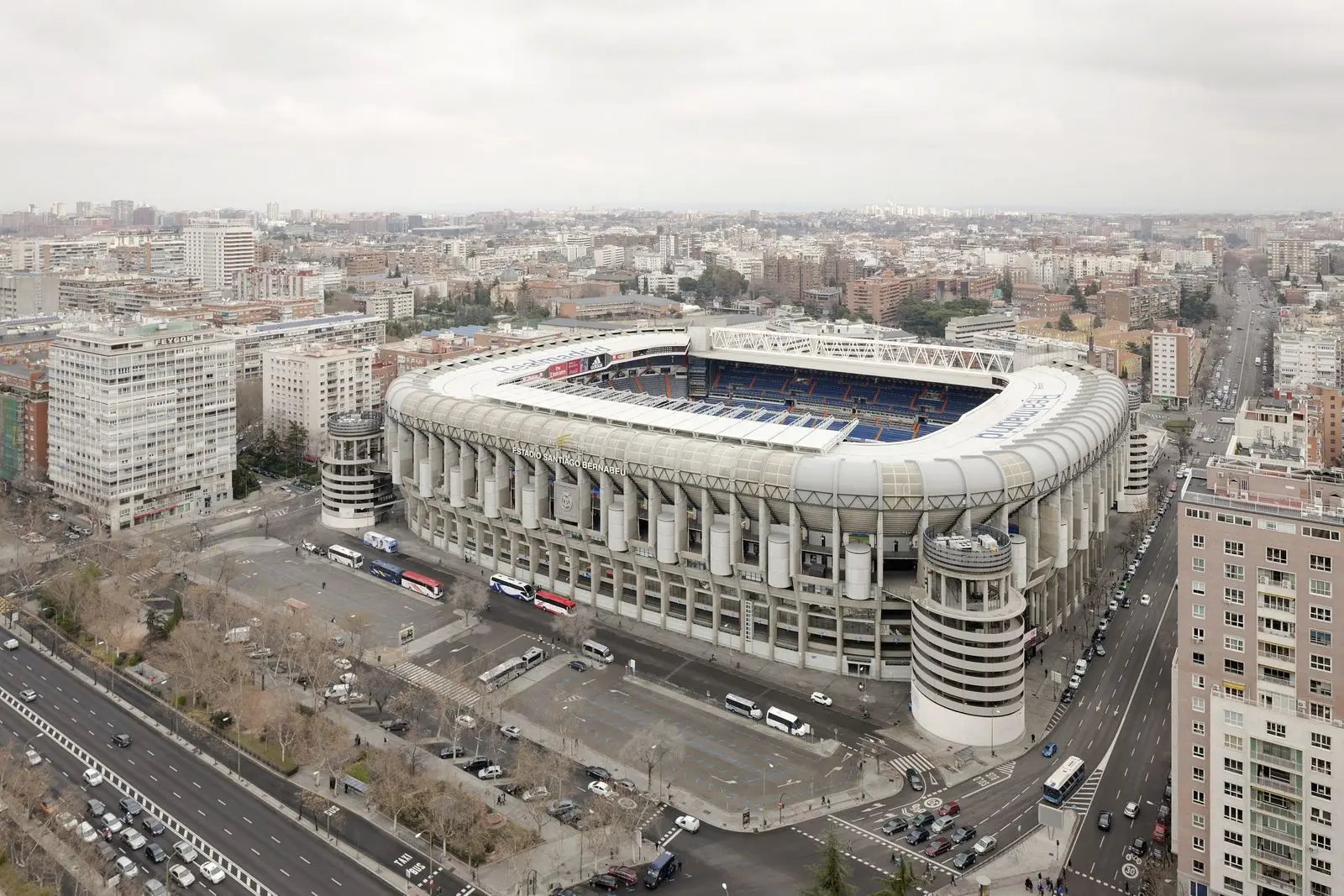 Aerial view of the modern Santiago Bernabéu Stadium exterior and surrounding city streets in Madrid