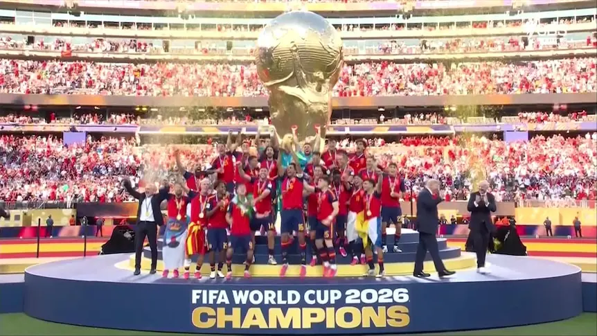 Spain football team celebrating with the FIFA World Cup trophy.
