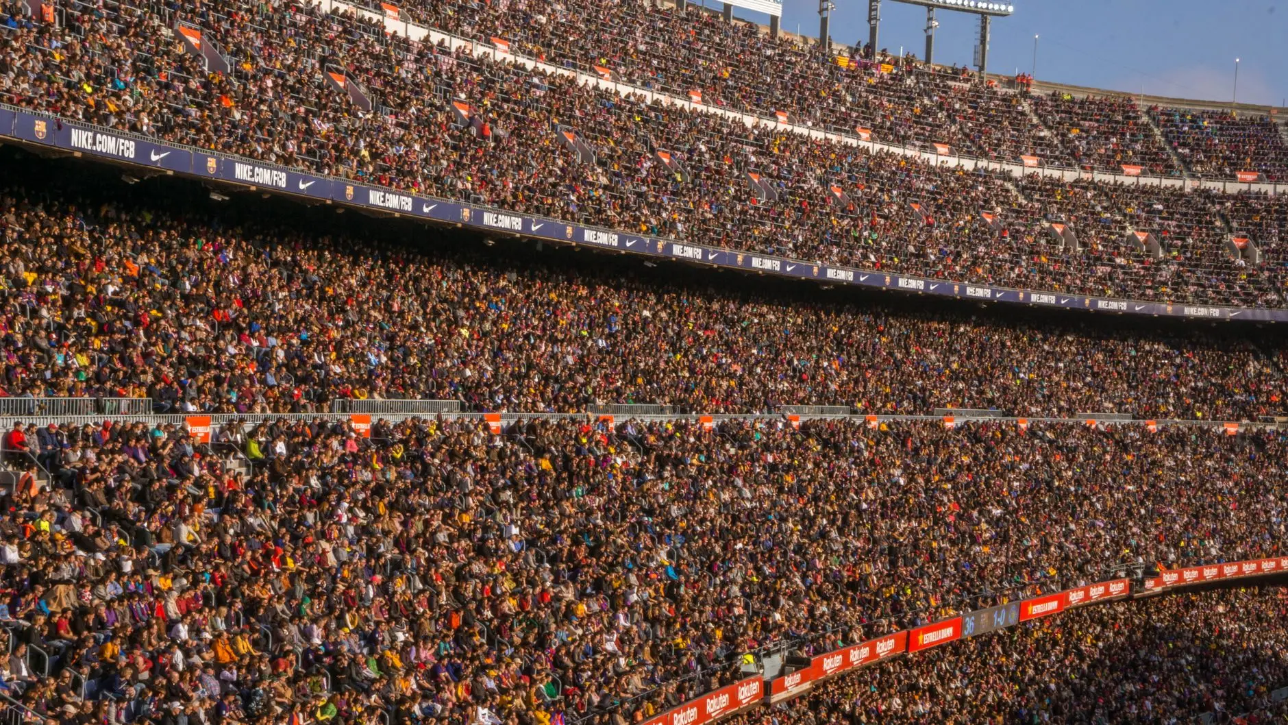 Crowded stands of FC Barcelona stadium with Nike and Rakuten advertising banners