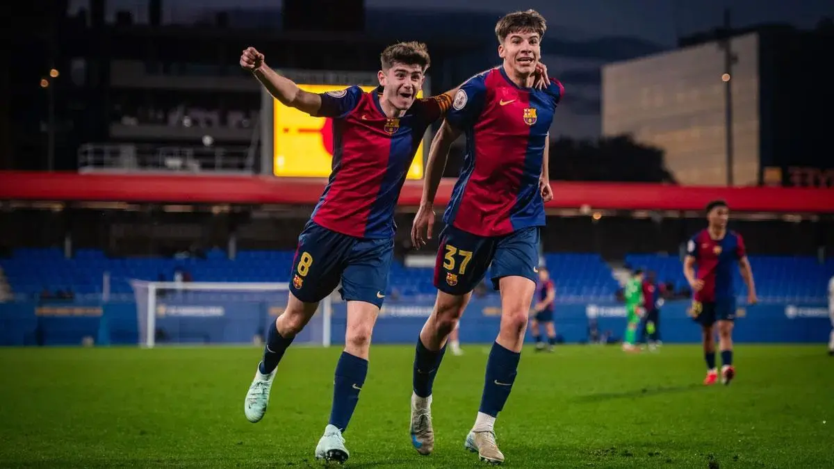 Jofre Torrents wearing a FC Barcelona jersey celebrating a goal with a teammate on a soccer pitch