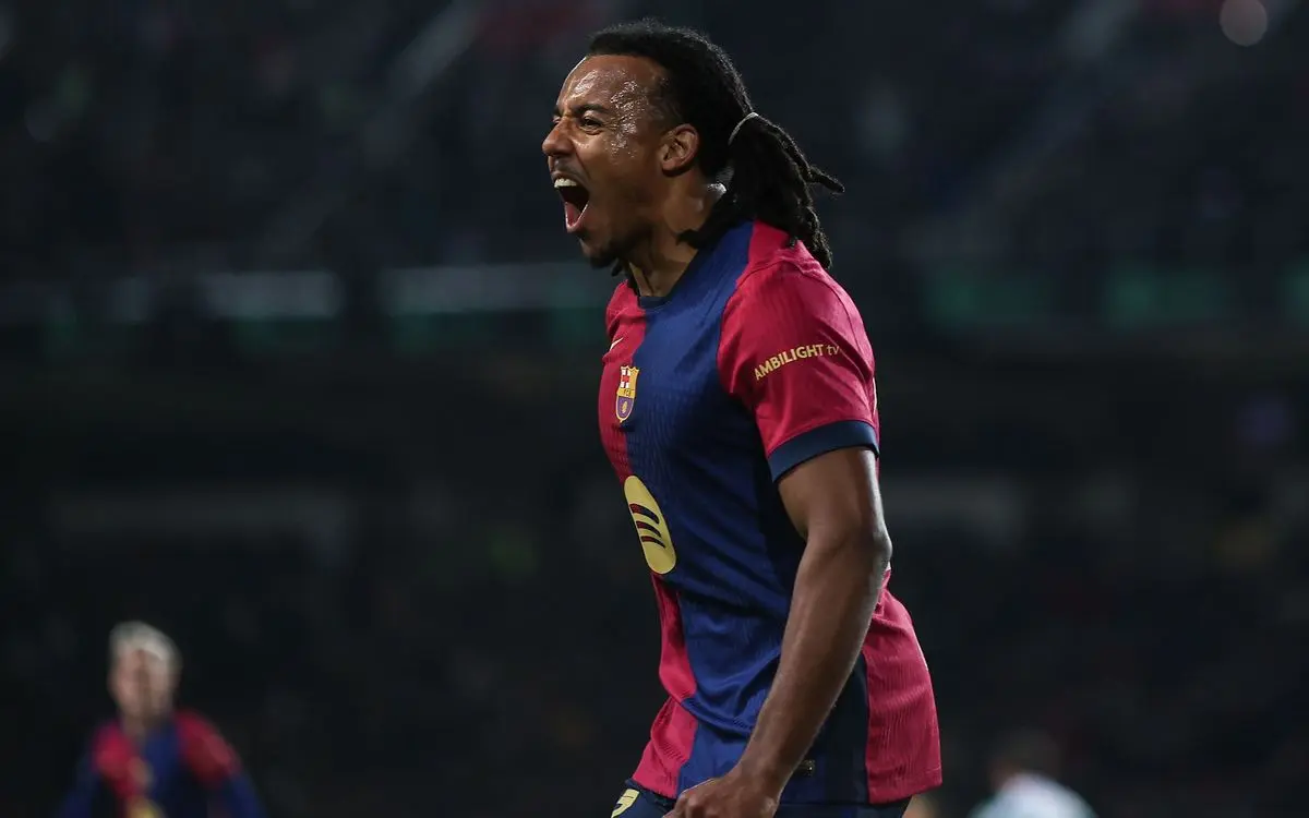 Jules Koundé shouting in celebration while wearing a FC Barcelona home jersey during a match