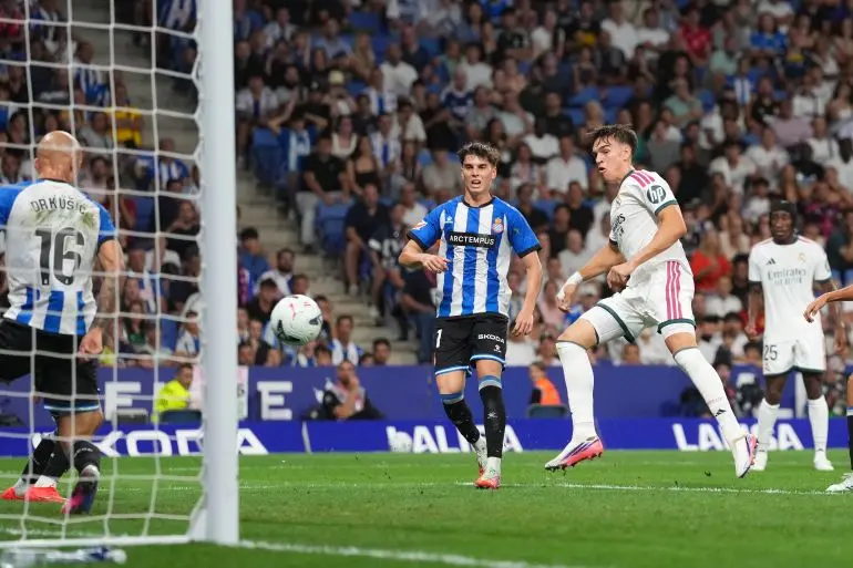 Real Madrid and Espanyol players competing for the ball near the goal during a La Liga match