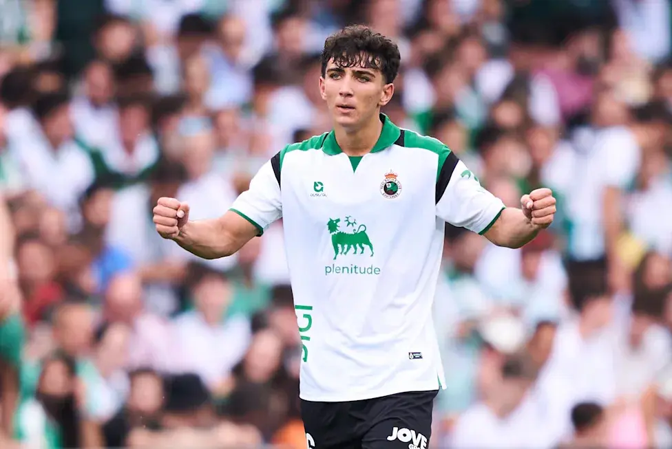 Sergio Martinez celebrating in a white and green Racing de Santander kit during a match