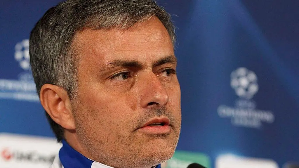 Close-up portrait of Jose Mourinho during a press conference with a Champions League background